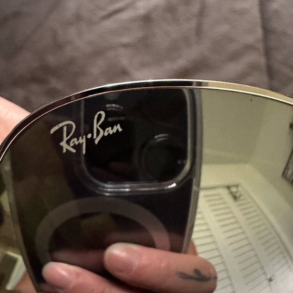 Mirrored Ray Bans.